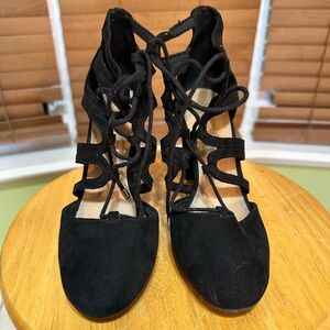 Women’s size 8 black heels with lace strings.